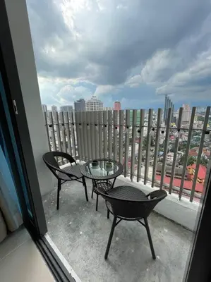 a balcony with a table and chairs and a view of a city at The Luxe & The Colony Infinitum by Romeo Bnb in Kuala Lumpur