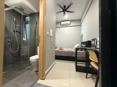 a bathroom with a shower and a toilet and a bed at The Luxe & The Colony Infinitum by Romeo Bnb in Kuala Lumpur
