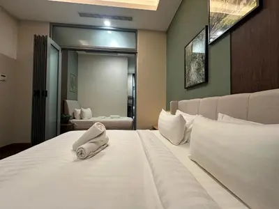 a bedroom with a white bed with a phone on it at Royce Residences by Romeo Bnb in Kuala Lumpur