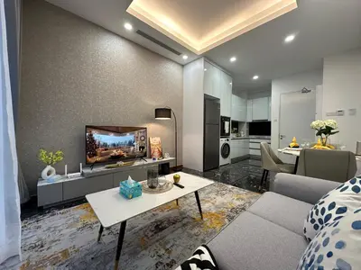 a living room with a couch and a tv at Royce Residences by Romeo Bnb in Kuala Lumpur
