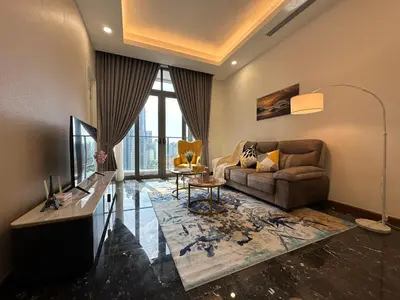 a living room with a couch and a television at Royce Residences by Romeo Bnb in Kuala Lumpur