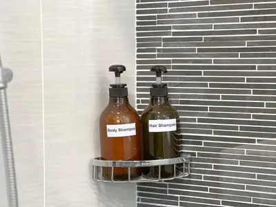 two bottles of honey strapped to a brick wall at D'Rapport Residences by Manhattan Group in Kuala Lumpur
