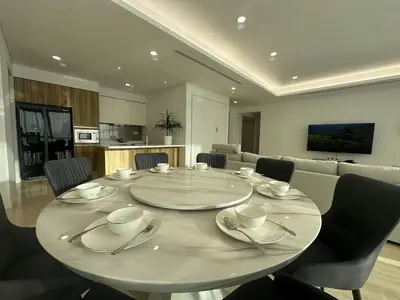 a table in a room with chairs and a kitchen at D'Rapport Residences by Manhattan Group in Kuala Lumpur