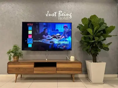 a living room with a flat screen tv on a wall at Just Being Home 5pax 1BR/1BA 1Queen/1Single/1Sofa in Kuala Lumpur