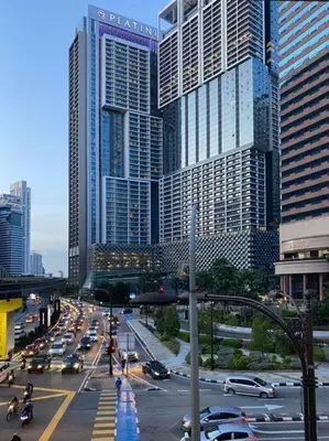 a busy city street with traffic in front of tall buildings at KLCC Suites at Platinum in Kuala Lumpur