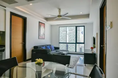 a living room with a couch and a glass table at Casa Residency Service Apartment By Moonlight in Kuala Lumpur