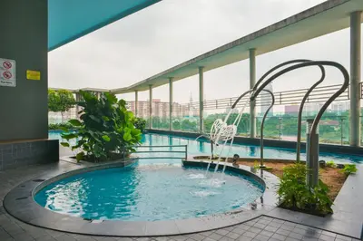 a swimming pool with a fountain in a building at Casa Residency Service Apartment By Moonlight in Kuala Lumpur
