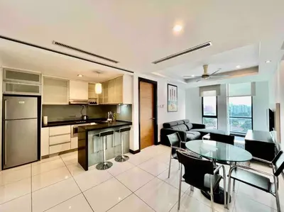 a kitchen and living room with a table and chairs at Casa Residency Service Apartment By Moonlight in Kuala Lumpur