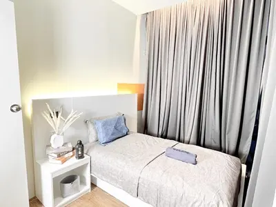 a small bedroom with a bed and a window at The Latrobe - Bangsar Trade Centre in Kuala Lumpur