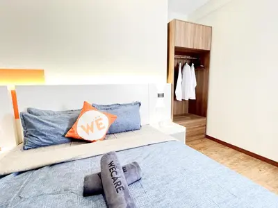 a bedroom with a large bed with blue pillows at The Latrobe - Bangsar Trade Centre in Kuala Lumpur