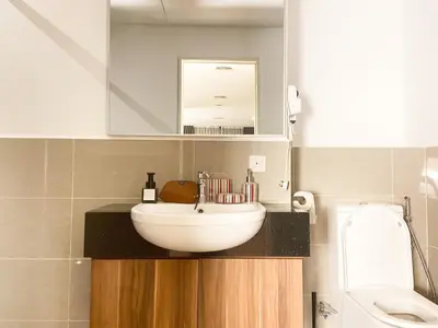 a bathroom with a white sink and a mirror at The Latrobe - Bangsar Trade Centre in Kuala Lumpur