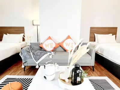 a living room with two beds and a couch at The Latrobe - Bangsar Trade Centre in Kuala Lumpur