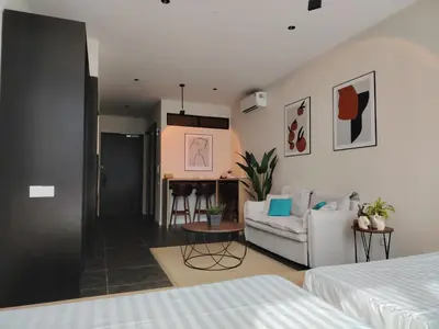 a room with a bed and a couch and a table at Scarletz Suites KLCC by KAN's in Kuala Lumpur