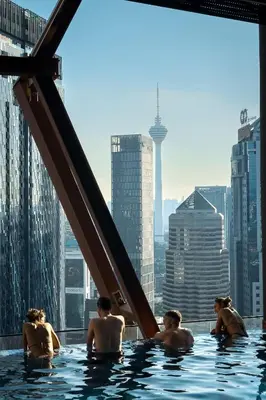 a group of people in a swimming pool on a skyscraper at Scarletz Suites KLCC by KAN's in Kuala Lumpur