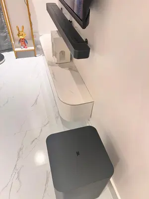a glass table with a television on a wall at Skyscraper 65 KL Highest Outdoor Bathtub Luxury Lavish Designer Suite Penthouse Lv65 in Kuala Lumpur