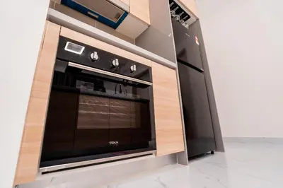 a microwave oven in a kitchen with a wall at Skyscraper 65 KL Highest Outdoor Bathtub Luxury Lavish Designer Suite Penthouse Lv65 in Kuala Lumpur