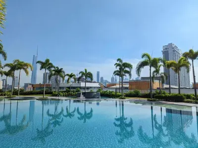 a large swimming pool with palm trees and a city at Skyscraper 65 KL Highest Outdoor Bathtub Luxury Lavish Designer Suite Penthouse Lv65 in Kuala Lumpur