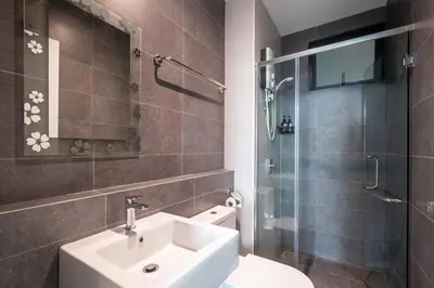 a bathroom with a sink and a shower and a toilet at Muji Home Lavile KL Sunway Velocity \u53cc\u5a01\u6c38\u4e50\u57ce\u4e2d\u6587\u623f\u4e1cPool in Kuala Lumpur