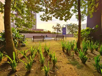 two benches in a park with trees and plants at KLCC VIEW Setapak Homestay 2BR KL view 8pax 15 min to KLCC PV21A R in Kuala Lumpur