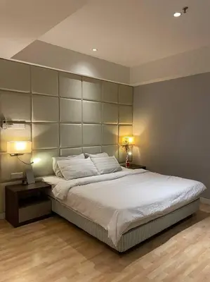 a bedroom with a large white bed with two lamps at D’ Majestic Place by Bimbee in Kuala Lumpur