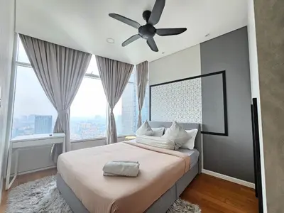 a bedroom with a large bed with a ceiling fan at Sky Suites & Residence KLCC Kuala Lumpur in Kuala Lumpur