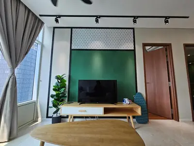 a living room with a tv and a green wall at Sky Suites & Residence KLCC Kuala Lumpur in Kuala Lumpur