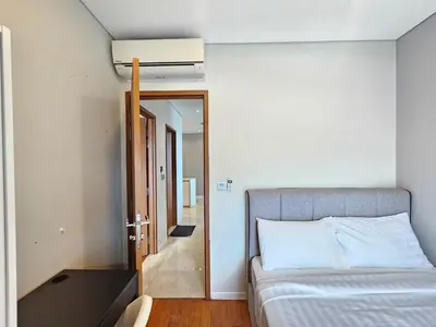 a bedroom with a bed and a door to a hallway at Sky Suites & Residence KLCC Kuala Lumpur in Kuala Lumpur
