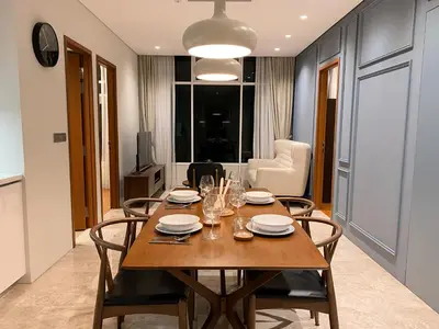a dining room with a wooden table and chairs at Sky Suites & Residence KLCC Kuala Lumpur in Kuala Lumpur