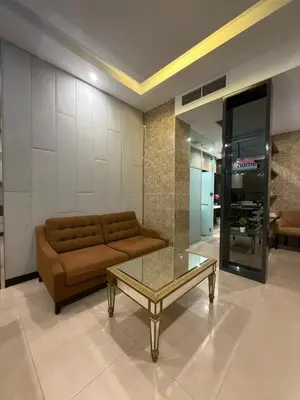 a living room with a couch and a glass table at Dorsett Bukit Bintang in Kuala Lumpur