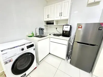 a kitchen with a washing machine and a refrigerator at Simple Arte Mont Kiara 1B1B 4 Pax Mitec Matrade in Kuala Lumpur