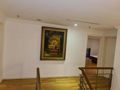 a painting on the wall of a white wall at Raymond Suites at Times Square kuala Lumpur in Kuala Lumpur