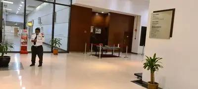 a man standing in a hallway in a building at Raymond Suites at Times Square kuala Lumpur in Kuala Lumpur