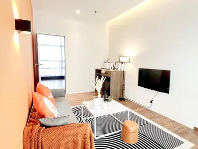 a living room with a couch a table and a tv at The Lonsdale - Bangsar Trade Centre in Kuala Lumpur