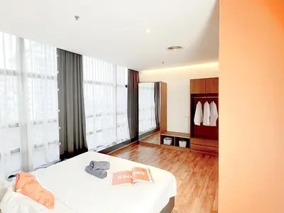 a hotel room with a bed and some windows at The Lonsdale - Bangsar Trade Centre in Kuala Lumpur