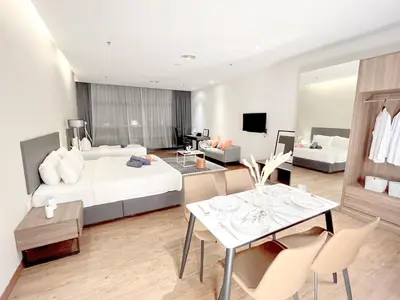 a hotel room with a bed and a dining room at The Bourke - Bangsar Trade Centre in Kuala Lumpur