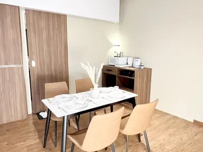 a dining room with a white table and chairs at The Bourke - Bangsar Trade Centre in Kuala Lumpur
