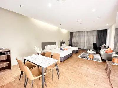 a living room with a bed and a table and chairs at The Bourke - Bangsar Trade Centre in Kuala Lumpur
