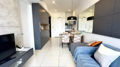 a living room with a blue couch and a television at Balcony Unit II & The Robertson Residence 33f in Kuala Lumpur