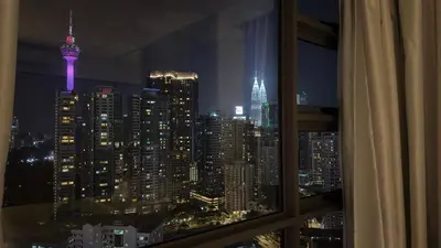 a view of a city skyline at night from a window at Balcony Unit II & The Robertson Residence 33f in Kuala Lumpur