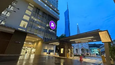a building with a purple sign on the side of it at Balcony Unit II & The Robertson Residence 33f in Kuala Lumpur