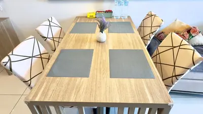 a long wooden table with chairs in a room at Balcony Unit II & The Robertson Residence 33f in Kuala Lumpur