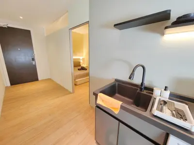 a kitchen with a sink and a mirror at The Tranquil - Bangsar Trade Centre in Kuala Lumpur