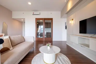 a living room with a couch and a table at UNA Residence By Feel Home Malaysia opposite Sunway Velocity Mall in Kuala Lumpur
