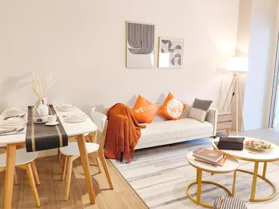 a living room with a white couch and a table at The Ovation - Bangsar Trade Centre in Kuala Lumpur