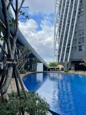 a large blue swimming pool next to a tall building at Arte Mont Kiara_Publika_Solaris in Kuala Lumpur