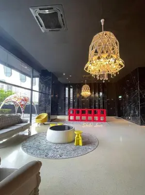 a living room with a chandelier and a table and chairs at Arte Mont Kiara_Publika_Solaris in Kuala Lumpur