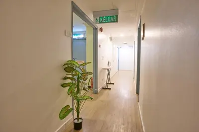 a hallway with a plant and a sign on the wall at Hotel Bintang Kuala Lumpur in Kuala Lumpur
