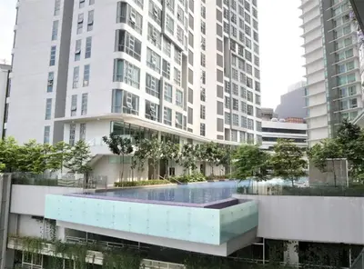 a large building with a swimming pool in front of it at MyCrib19*The Robertson KL - Bukit Bintang Pavilion in Kuala Lumpur
