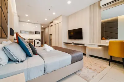 a bedroom with a large bed and a television at Societe Hartamas in Kuala Lumpur
