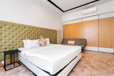 a bedroom with a large bed with a large headboard at Expressionz Kuala Lumpur in Kuala Lumpur